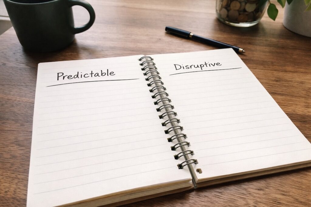 Open notebook on a wooden desk with handwritten budget categories and savings notes, illustrating the structural difference between an emergency fund vs sinking funds and how separating predictable costs from disruptions creates financial stability.